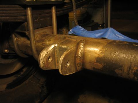 1979 Ford Bronco - This photo shows a close-up view of a vehicle's rear axle assembly, focusing on the leaf springs and U-bolt mounting points.