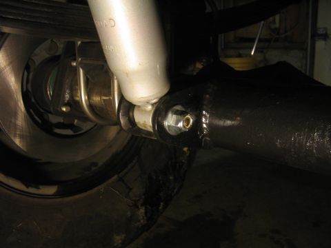 1979 Ford Bronco - Close-up view of a vehicle's rear axle and shock absorber assembly, showing mechanical components.