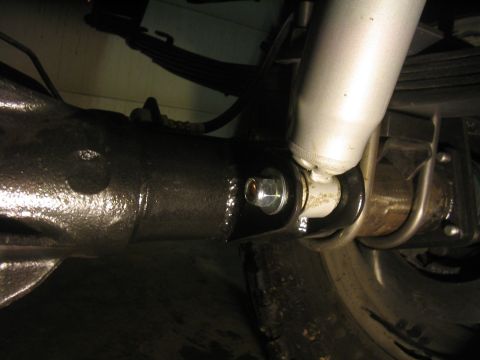 1979 Ford Bronco - Detail of a vehicle's rear axle assembly, showing the shock absorber mount.