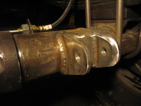 1979 Ford Bronco - Custom suspension mount welded onto the rear axle housing with visible brake line.