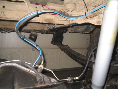 1979 Ford Bronco - Close-up view of the suspension and brake system components on a vehicle's undercarriage.