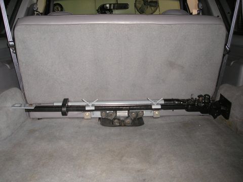 1995 Ford Bronco - A hi-lift jack is secured to the floor of the vehicle's cargo area.