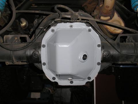 1995 Ford Bronco - A newly painted differential cover is bolted onto the rear axle of a vehicle.