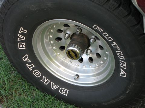1991 Ford F-150 - Close-up of a Dakota RVT tire on a polished aluminum wheel with chrome center cap.