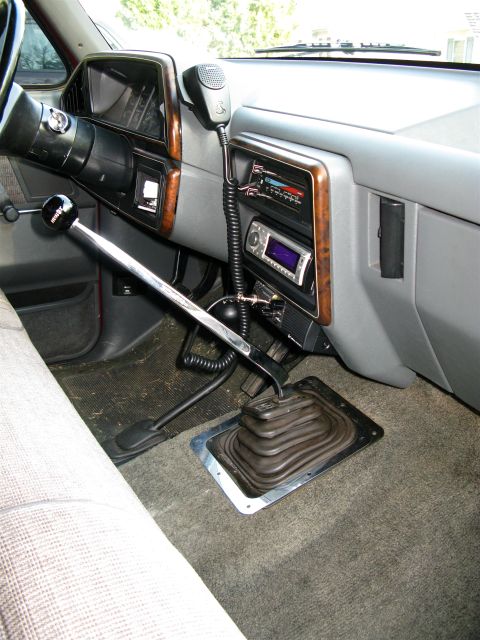 1991 Ford F-150 - The interior of a 1991 Ford F-150 features a CB radio and a manual transmission shifter.
