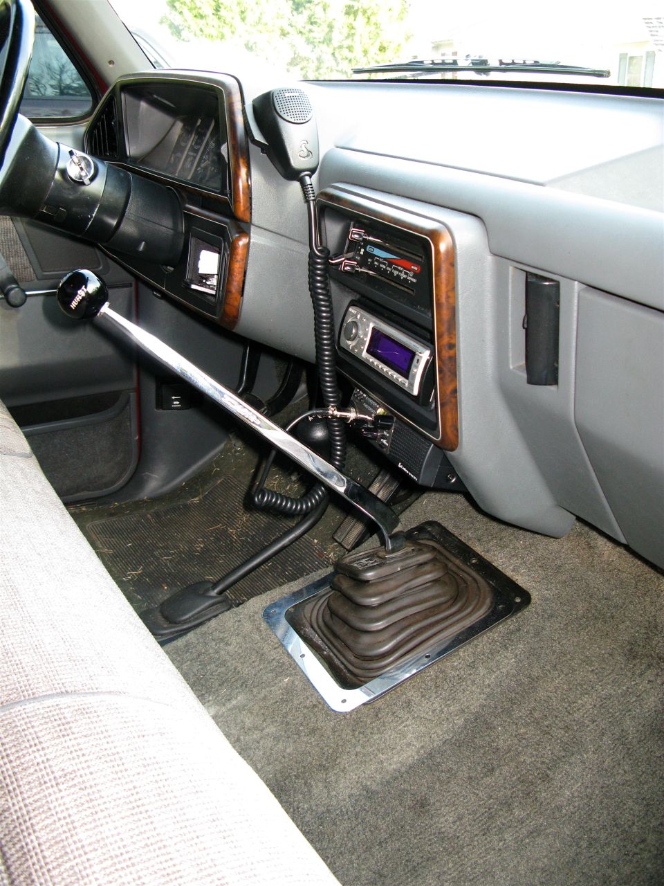 Interior shot of a 1991 Ford F-150, showing the dashboard, steering wheel, gear shifter, and radio