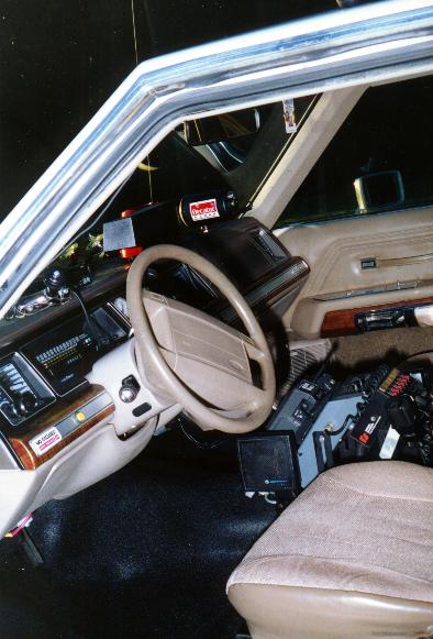 1991 Ford Crown Victoria - Interior view of a 1991 Ford Crown Victoria, equipped with police radio and other gear.
