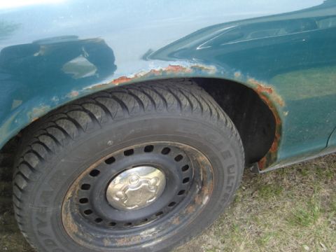 2003 Ford Crown Victoria - Rust damage is visible on the fender and wheel well of this vehicle.