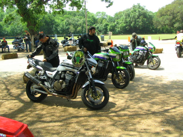 Row of sport motorcycles parked at an outdoor gathering