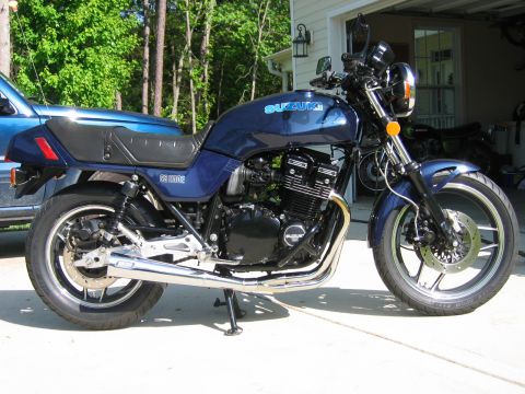 1985 Ford LTD Crown Victoria - Photograph of a blue Suzuki standard motorcycle parked on a driveway, not a technical document.