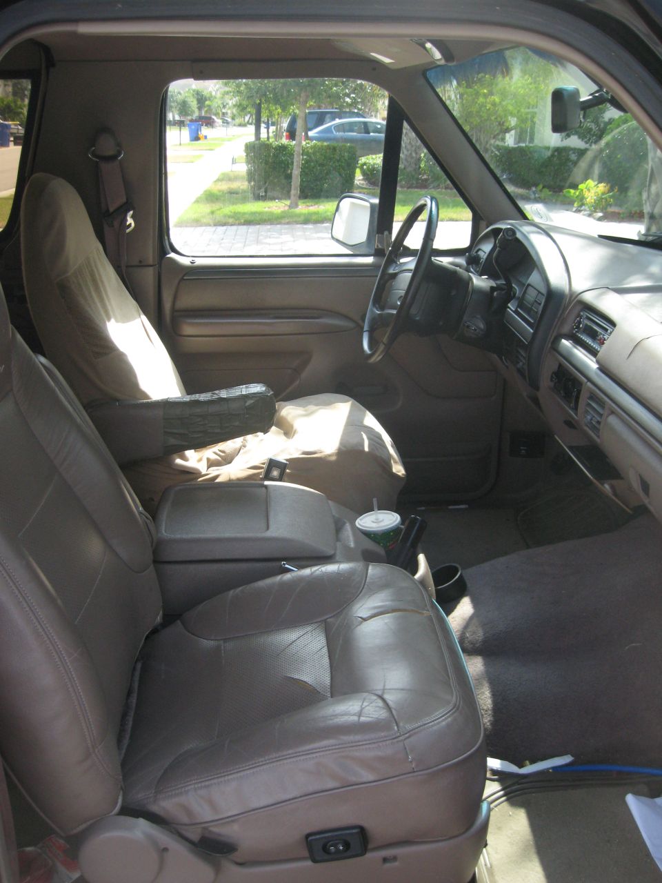 Interior view of a 1995 Ford Bronco, showing the driver's seat, dashboard, and passenger seat.