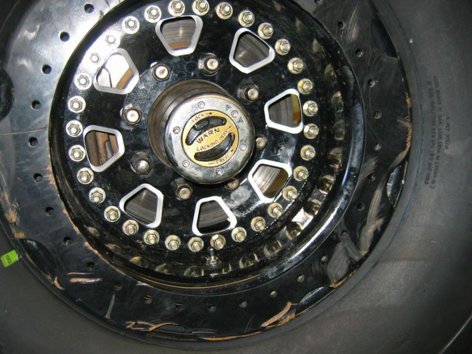 Close-up of a vehicle's wheel hub and brake rotor assembly. Warn locking hub visible.
