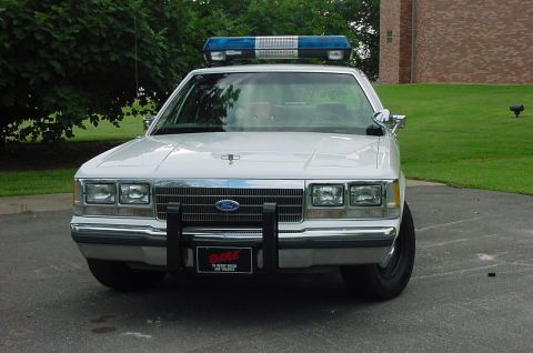 1991 Ford Crown Victoria - This 1991 Ford Crown Victoria police car is parked outdoors with a light bar on its roof.