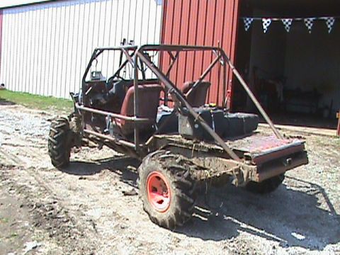 1987 Ford Bronco - This custom-built buggy appears to be modified for off-road use, with large, knobby tires and a sturdy roll cage.