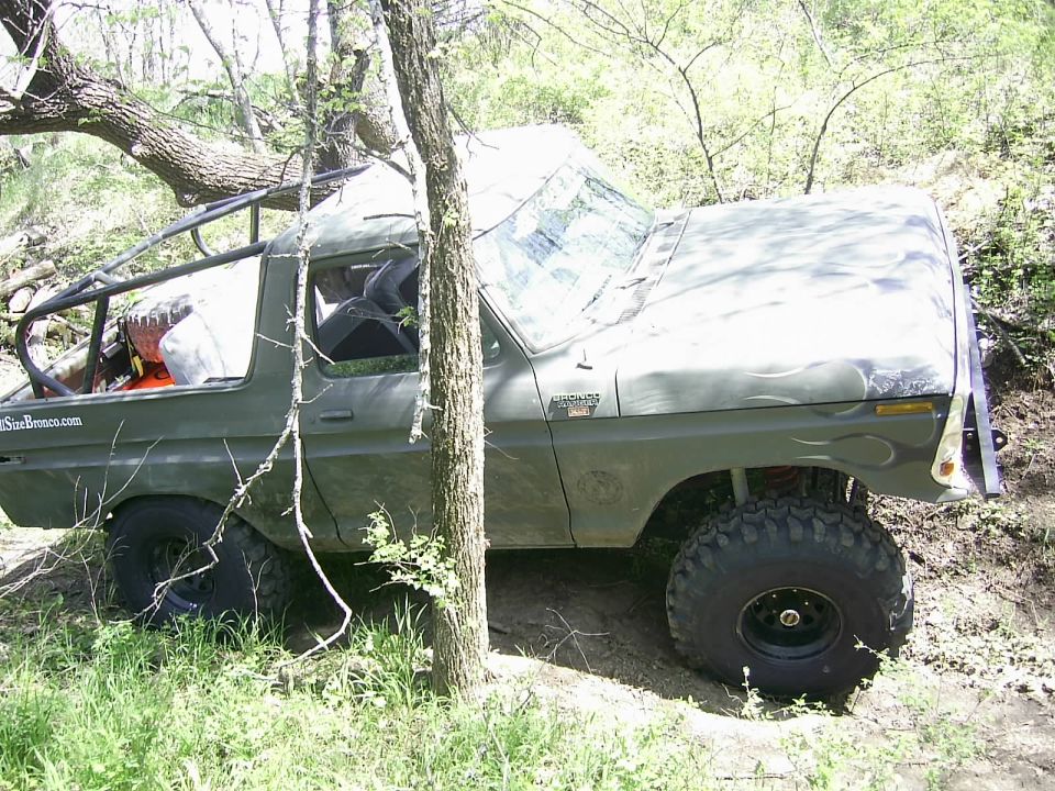 Olive green off-road SUV with flame decals, 3/4 front view. Visible text: "StarBronco.com"