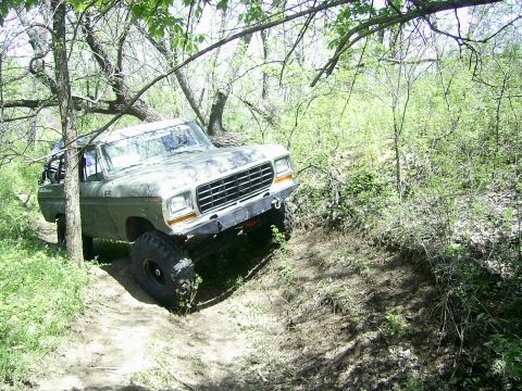 1978 Ford Bronco - This 1978 Ford Bronco navigates a rough, wooded terrain on a dirt path.