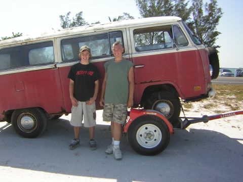 1971 Volkswagen Vanagon - Two boys stand next to a red and white 1971 Volkswagen Vanagon with a U-Haul trailer.