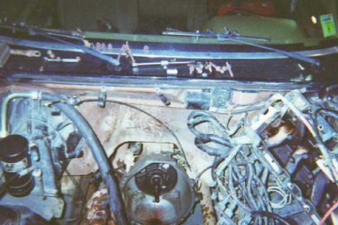 1988 Ford Bronco - A shot of an empty engine bay, notice the scattered bolts below the windshield. This would prove to be a problem later.