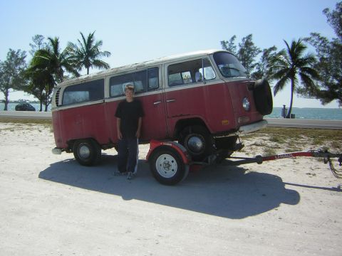 1971 Volkswagen Vanagon - This vintage van, likely a Volkswagen Type 2, is being transported on a trailer near the coast.