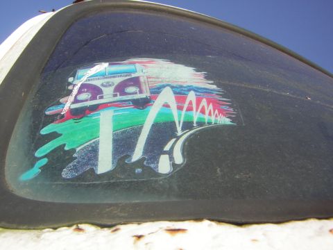 1971 Volkswagen Vanagon - A colorful sticker depicting a Volkswagen bus is affixed to the vehicle's window.