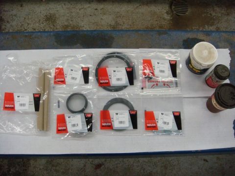 1996 Ford Bronco - Photograph of packaged Warn winch rebuild parts and seals arranged on a workbench, not a technical document.