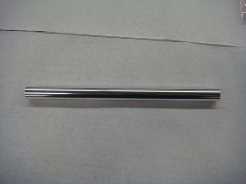 1996 Ford Bronco - Photograph of a machined metal tube on a workbench, not a technical document.