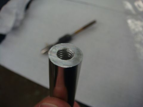1996 Ford Bronco - Photograph of a freshly tapped threaded bore in a metal rod, not a technical document.