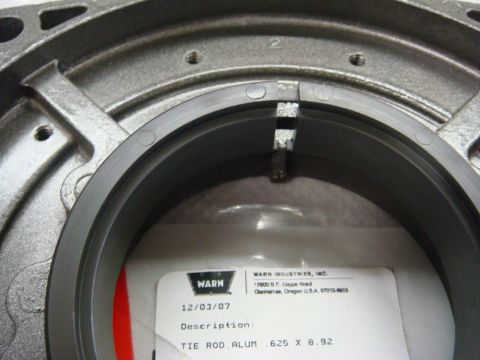 1996 Ford Bronco - Photograph inside a Warn winch housing showing a parts label, not a technical document.