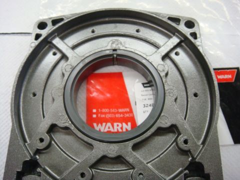 1996 Ford Bronco - Photograph of a Warn winch housing casting and seal during rebuild, not a technical document.