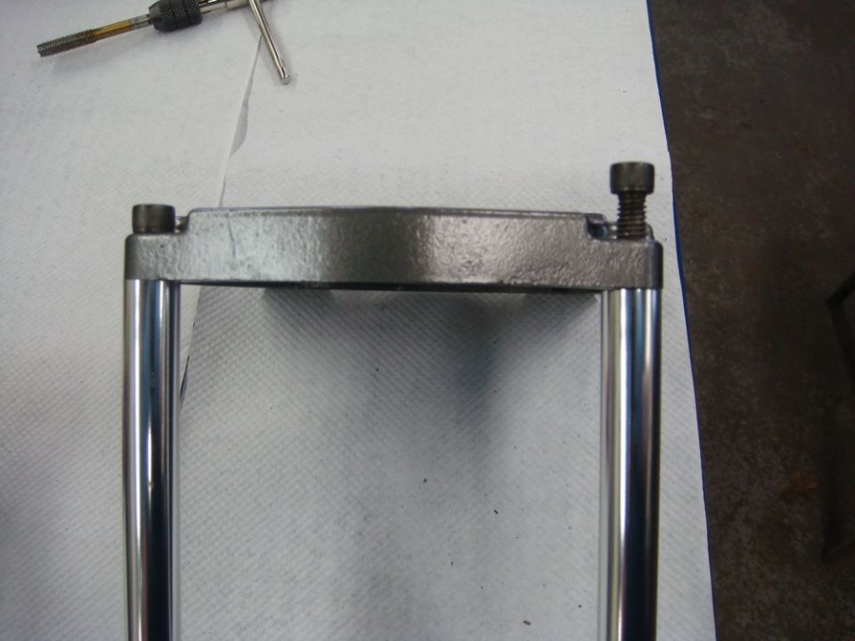Photo of a fabricated tie-bar assembly with two polished rods