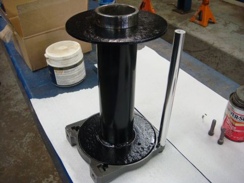 1996 Ford Bronco - Workshop photo of a freshly painted winch drum/support tube on a bench, not a technical document.