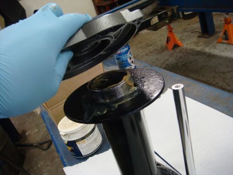 1996 Ford Bronco - Workshop photo of a winch end plate being assembled onto the drum, not a technical document.