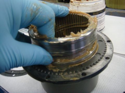 1996 Ford Bronco - Workshop photo of a winch gear cup being removed from the carrier, not a technical document.