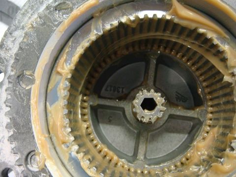 1996 Ford Bronco - Workshop close-up of a winch ring gear and pinion in grease, not a technical document.