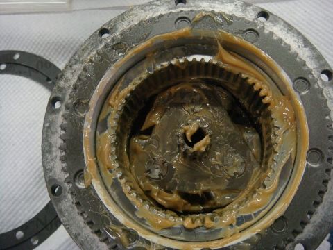 1996 Ford Bronco - Workshop photo of a winch gearbox interior packed with grease, not a technical document.