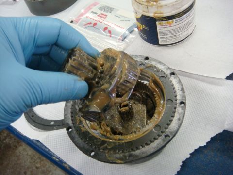 1996 Ford Bronco - Workshop photo of a winch planetary gear cluster being handled, not a technical document.