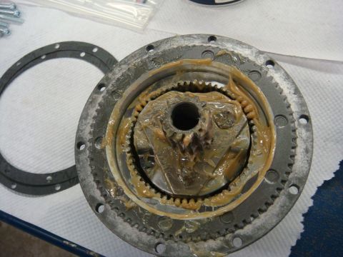 1996 Ford Bronco - Workshop photo of a winch gearbox interior with gasket and grease, not a technical document.