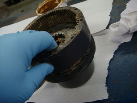 1996 Ford Bronco - Workshop photo of a winch gear housing being handled, not a technical document.
