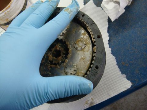 1996 Ford Bronco - Workshop photo of a grease-packed winch gearbox being assembled, not a technical document.