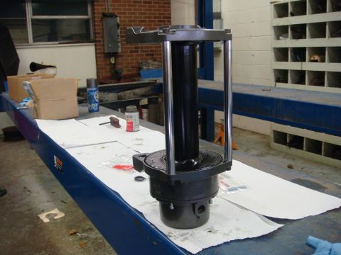 1996 Ford Bronco - A mechanical part is laid out on a workbench, possibly for repair or inspection.