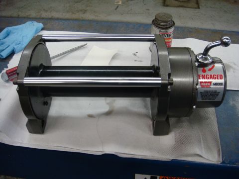 1996 Ford Bronco - A close-up view of a winch drum assembly, possibly for a vehicle or boat, resting on a surface.