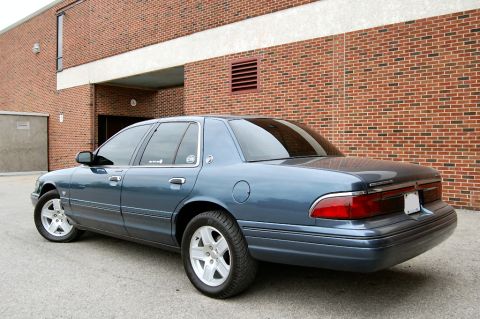 1985 Mercury Grand Marquis - This blue sedan has a distinctive body style that does not match the claimed model year.