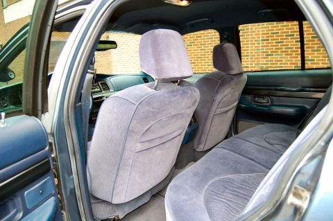 1985 Mercury Grand Marquis - The interior of a 1985 Mercury Grand Marquis features blue velour seats and matching door panels.