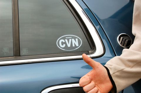 1985 Mercury Grand Marquis - A hand gives a thumbs up next to a sticker on a blue vehicle's window.