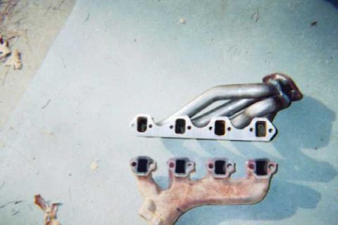 1988 Ford Bronco - Stock exhaust manifold compared to the new headers. Notice the port size difference.