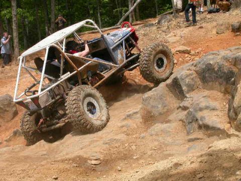 1990 Ford Bronco - This heavily modified off-road buggy navigates a steep, rocky terrain during a race.