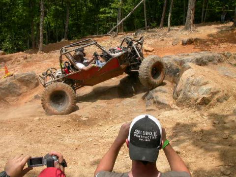 1990 Ford Bronco - An off-road buggy navigates a challenging rocky terrain during an event.