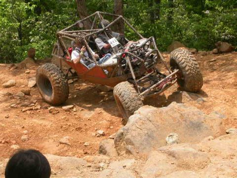 1990 Ford Bronco - This custom-built buggy navigates a rocky trail during an off-road event.