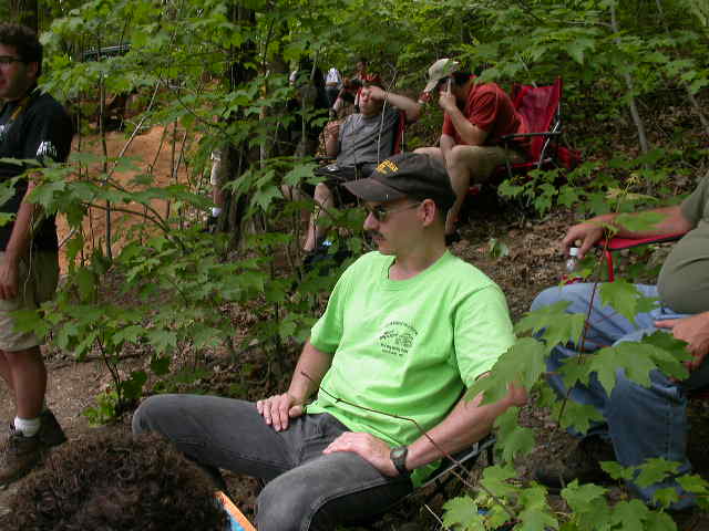 The crowd sitting in the woods right above the ledge below Kodak Rock.
