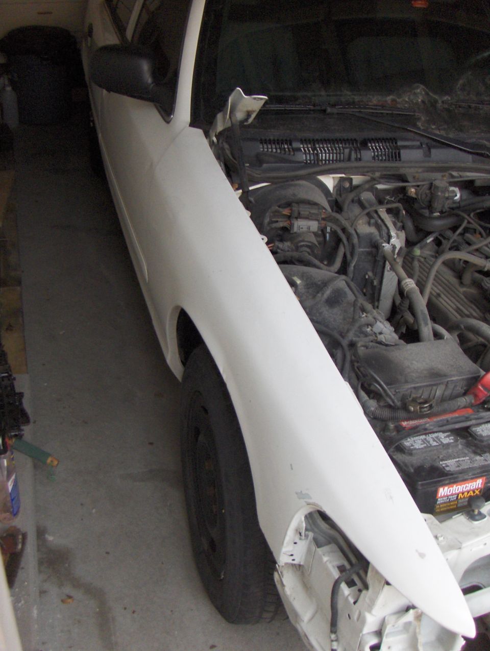 2003 Ford Crown Victoria front fender and engine bay with the hood open